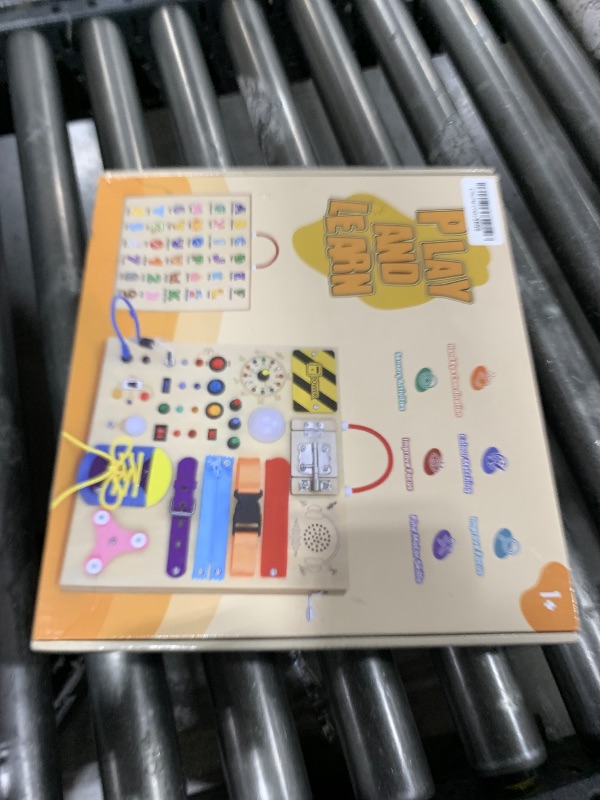 Photo 1 of 23 in 1 Busy Board Montessori Toys for 1-3 Year Old Wooden Learning Educational Toy for Toddlers with 15 Switches, 26 LED Lights, Music Boxes, Locks,Zippers Toddler Sensory Toys for Soothing A Baby