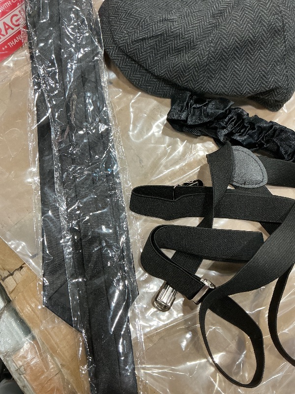 Photo 1 of  a 1920s style accessory costume kit, likely including a newsboy cap, suspenders, a bow tie, and other