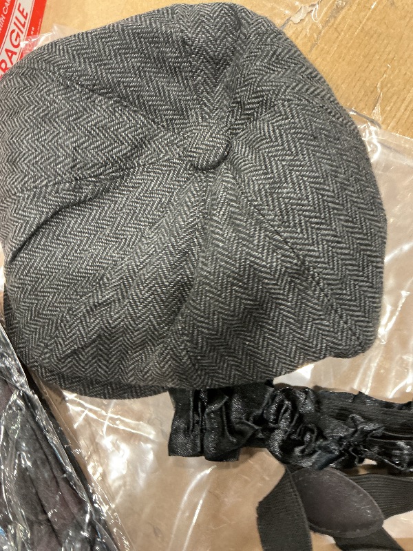 Photo 1 of  a 1920s style accessory costume kit, likely including a newsboy cap, suspenders, a bow tie, and other