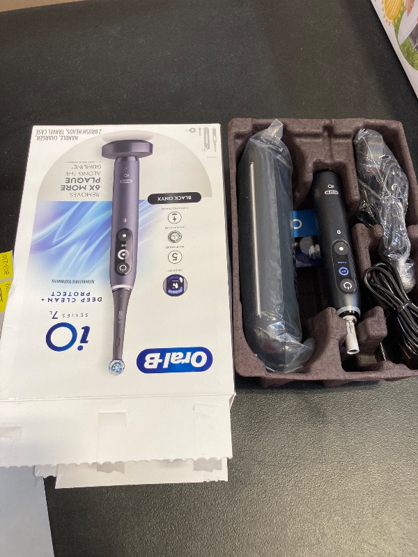 Photo 1 of Oral-B iO Deep Clean + Protect Rechargeable Electric Toothbrush, Black with a iO Series 7 Toothbrush, 2 Replacement Brush Heads, and a Charging Travel Case