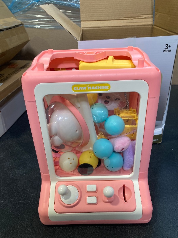 Photo 1 of Rabbit Claw Machine for Kids, Mini Vending Machine with Game Coins & Music, Prize Dispenser Toys for Girls and Boys, Electronic Claw Game Machine for Party Birthdays, Includes 30 Mini Toys