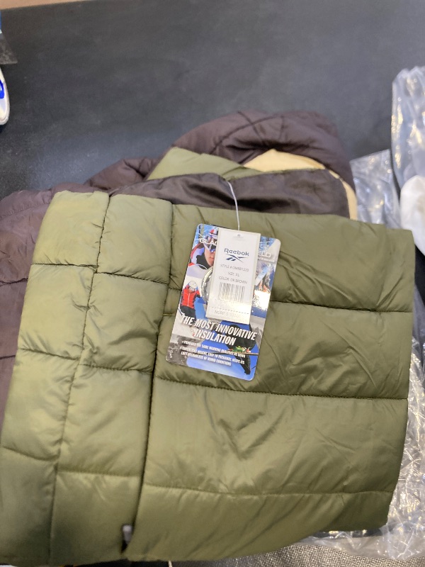 Photo 1 of Reebok Men's Jacket – Lightweight Hooded Quilted Puffer Coat – Warm Insulated Winter Jacket for Men (S-4X), Size X-Large, Dark Brown