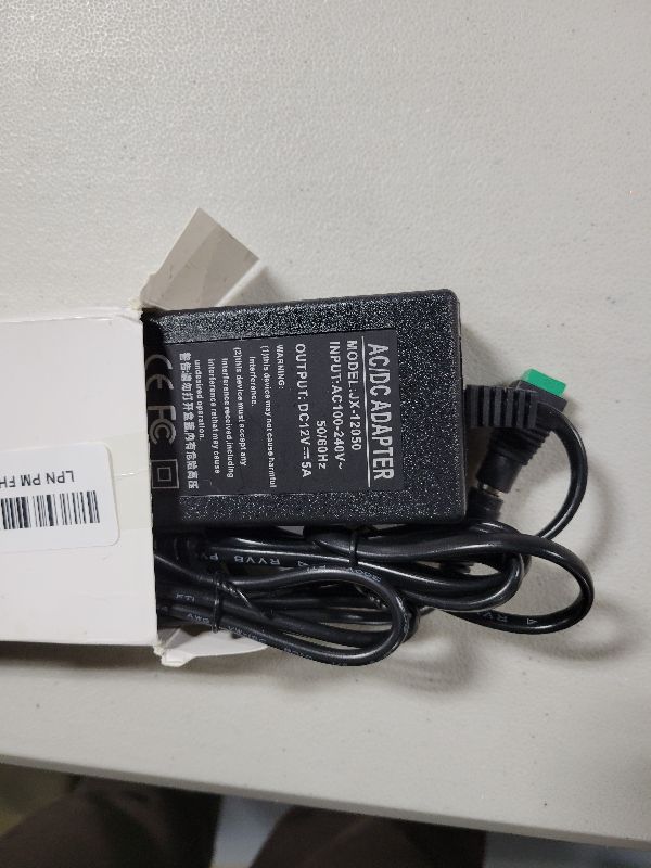 Photo 1 of 12V 5A Power Adapter 60W AC/DC Converter Suitable for LED Strips, Surveillance Cameras, and Computer Monitors. Features a 5.5x2.5mm Connector and a 2.1mm Plug.