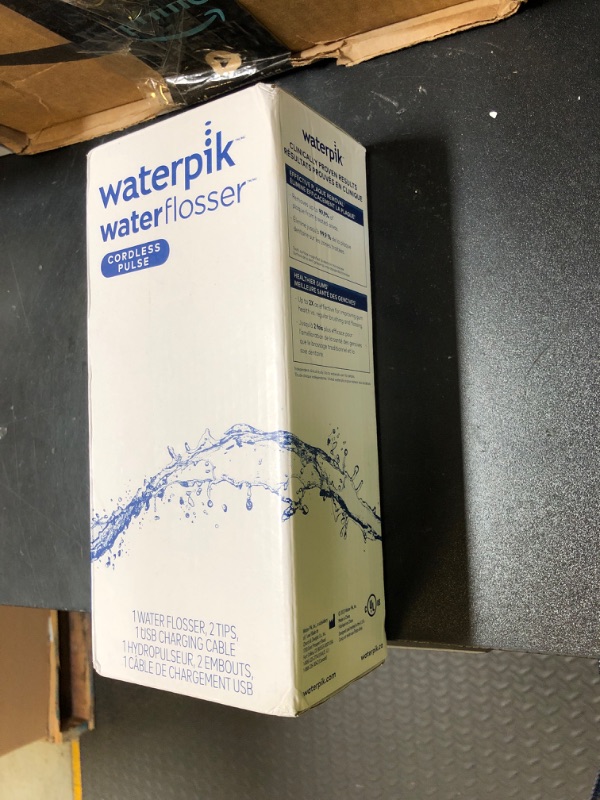 Photo 1 of Waterpik Cordless Pulse Rechargeable Portable Water Flosser for Teeth, Gums, Braces Care and Travel with 2 Flossing Tips, Waterproof, ADA Accepted, WF-20 White, Packaging May Vary