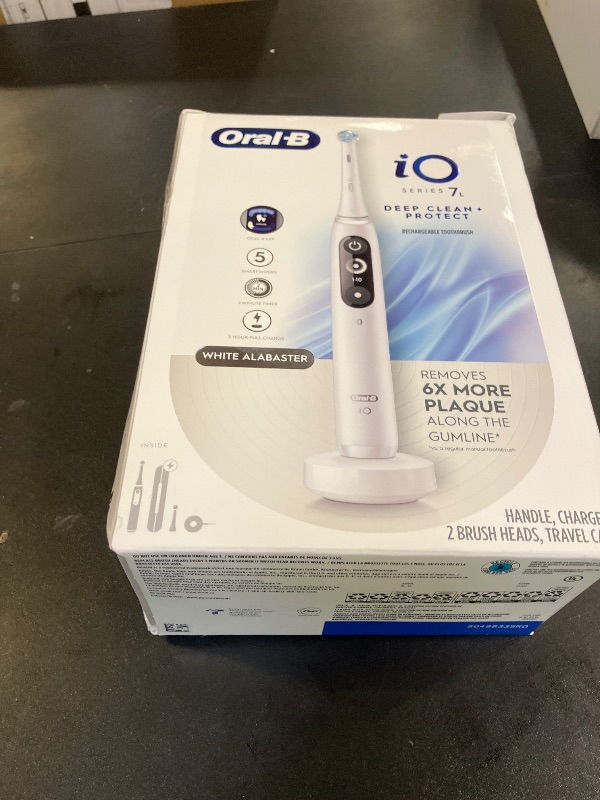Photo 1 of Oral-B iO Deep Clean + Protect Rechargeable Electric Toothbrush, White with a iO Series 7 Toothbrush, 2 Replacement Brush Heads, and a Charging Travel Case
