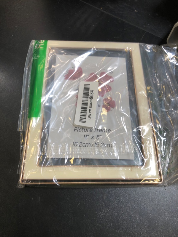 Photo 1 of Lyeasw 4x6 Floating Picture Frame, White Photo Frame with Gold Edging for 3.5x5, 4x6 up to 5x7 Picture, Tempered Glass Frame for Desk Vertical Display