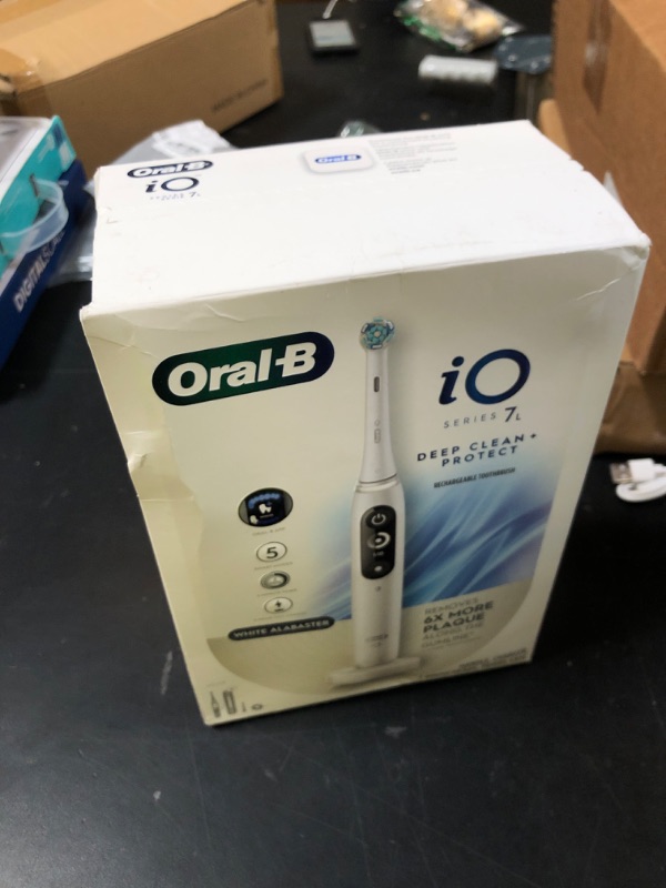 Photo 1 of Oral-B iO Deep Clean + Protect Rechargeable Electric Toothbrush, White with a iO Series 7 Toothbrush, 2 Replacement Brush Heads, and a Charging Travel Case