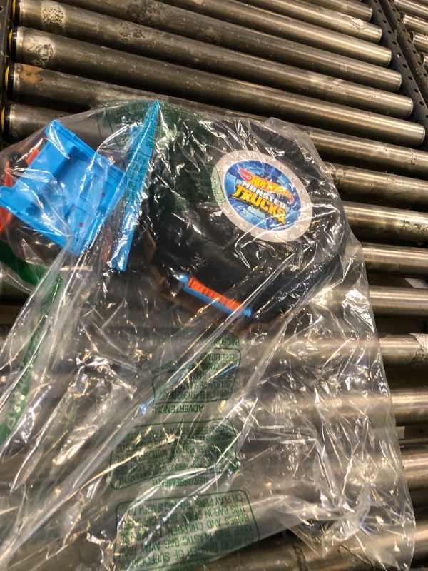 Photo 1 of Hot Wheels Toy Monster Trucks Playset, Tire-Shaped Case Transforms into Race Course, 3 Trucks & 4 Cars in 1:64 Scale, Stunt Tire (Amazon Exclusive)