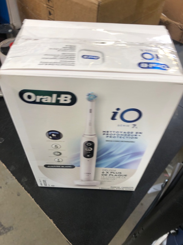 Photo 1 of Oral-B iO Deep Clean + Protect Rechargeable Electric Toothbrush, White with a iO Series 7 Toothbrush, 2 Replacement Brush Heads, and a Charging Travel Case