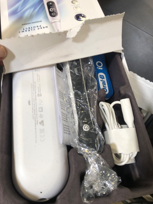 Photo 1 of Oral-B iO Deep Clean + Protect Rechargeable Electric Toothbrush, White with a iO Series 7 Toothbrush, 2 Replacement Brush Heads, and a Charging Travel Case