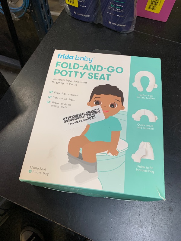 Photo 1 of Frida Baby Fold-and-Go Portable Potty Seat for Toilet, Foldable Travel Potty Seat for Toddler, Fits Round & Oval Toilets, Non-Slip Base, Handles, Includes Free Travel Bag