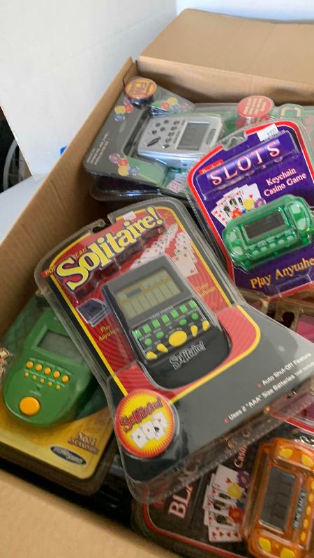 Photo 1 of BOX OF HANDHELD TOYS