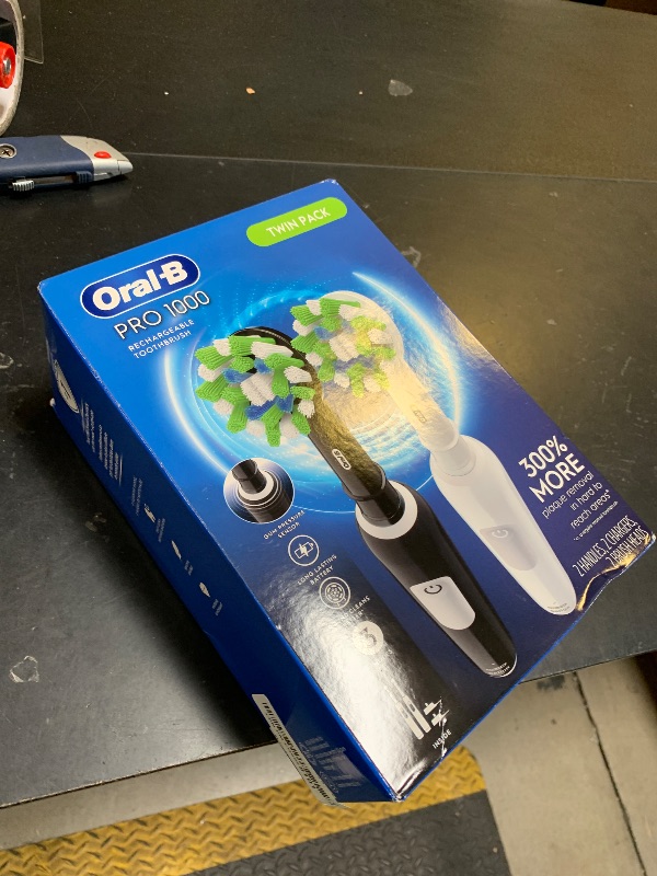 Photo 1 of Oral-B Pro 1000 CrossAction Electric Toothbrush, Black and White, 2 Count