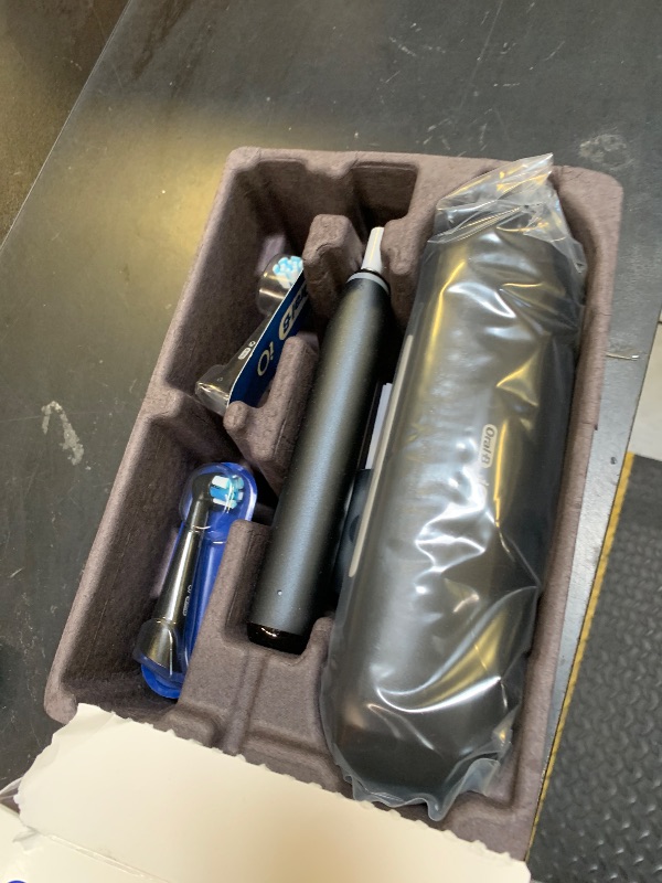 Photo 1 of Oral-B iO Deep Clean + Protect Rechargeable Electric Toothbrush, Black with a iO Series 7 Toothbrush, 2 Replacement Brush Heads, and a Charging Travel Case