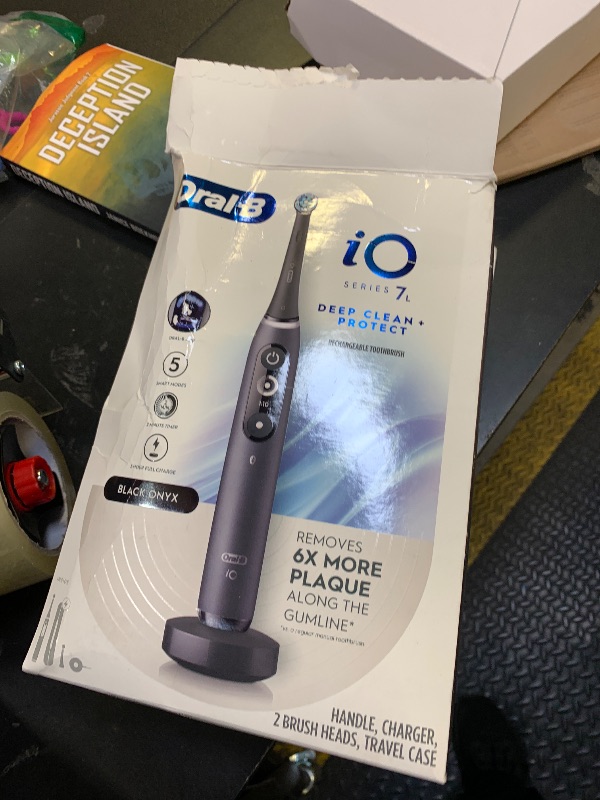 Photo 1 of Oral-B iO Deep Clean + Protect Rechargeable Electric Toothbrush, Black with a iO Series 7 Toothbrush, 2 Replacement Brush Heads, and a Charging Travel Case
