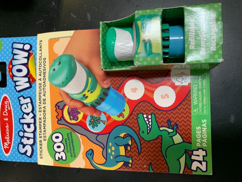 Photo 1 of Melissa & Doug Sticker Wow!™ 24-Page Activity Pad and Sticker Stamper, 300 Stickers, Arts and Crafts Fidget Toy Collectible Character – Dinosaur Creative Play Travel Toy for Girls and Boys 3+,