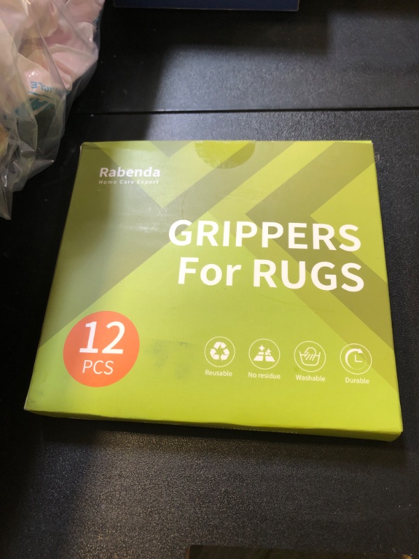 Photo 1 of Rabenda 12 Pcs Rug Tape, Non Slip Rug Pads Grippers for Hardwood Floors and Tiles, Reusable Carpet Tape for Area Rugs, Double-Sided Adhesive Rug Stickers Keep Corners Flat (Black)