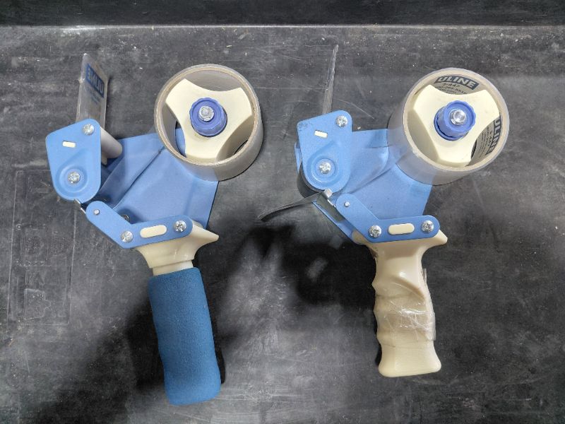 Photo 1 of 4- ULINE H-150 2" INDUSTRIAL SIDE LOADER TAPE DISPENSER (2 IN PICTURE, 4 TOTAL)