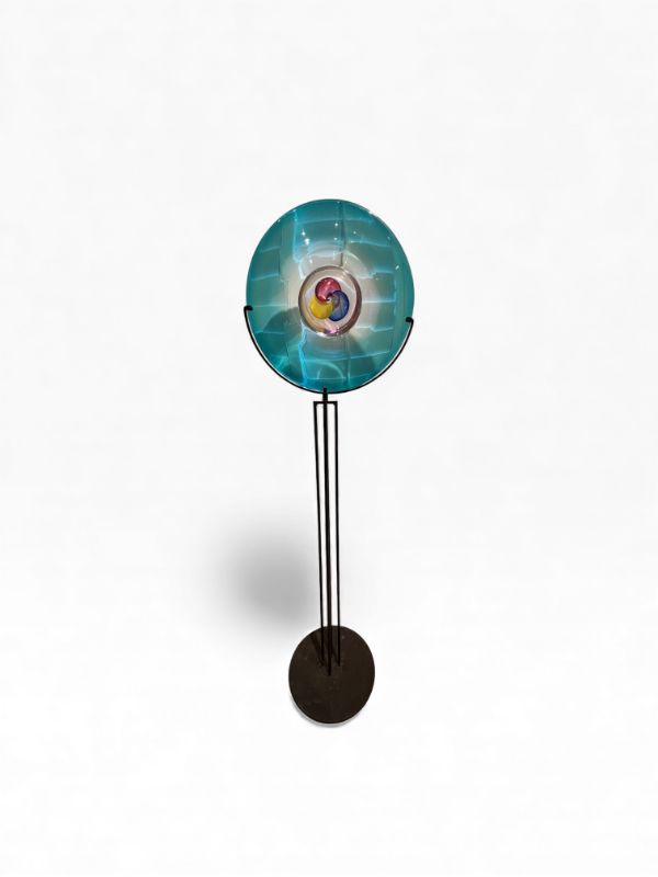 Photo 1 of BLUE GREEN GLASS MURANO POLIPO PLATE WITH RED YELLOW AND BLUE INSIDE CIRCLES ON BLACK METAL BASE ARTWORK PLATE IS 23” DIAMETER WITH TOTAL HEIGHT 72”