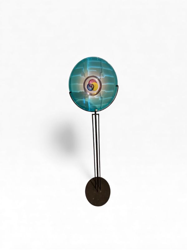 Photo 1 of BLUE GREEN GLASS MURANO POLIPO PLATE WITH RED YELLOW AND BLUE INSIDE CIRCLES ON BLACK METAL BASE ARTWORK PLATE IS 23” DIAMETER WITH TOTAL HEIGHT 72”