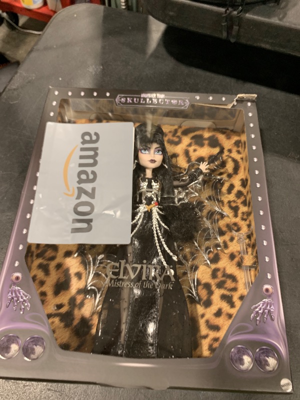 Photo 1 of Monster High Doll, Elvira, Mistress of The Dark Collectible in Black Faux Leather Dress with Silvery Batwing Cape and Premium Accessories (Amazon Exclusive)