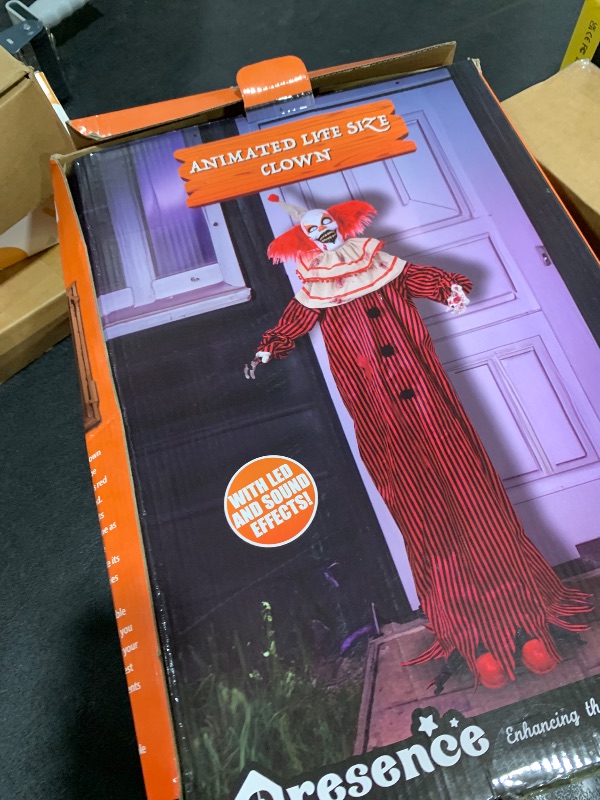 Photo 1 of Presence 72" Halloween Decorations Outdoor - Standing Animatronic Clown with Red Light Up Eyes, Motion and Sound Activated Moving Arms and Head, Scary Clown Halloween Yard Patio House Decor