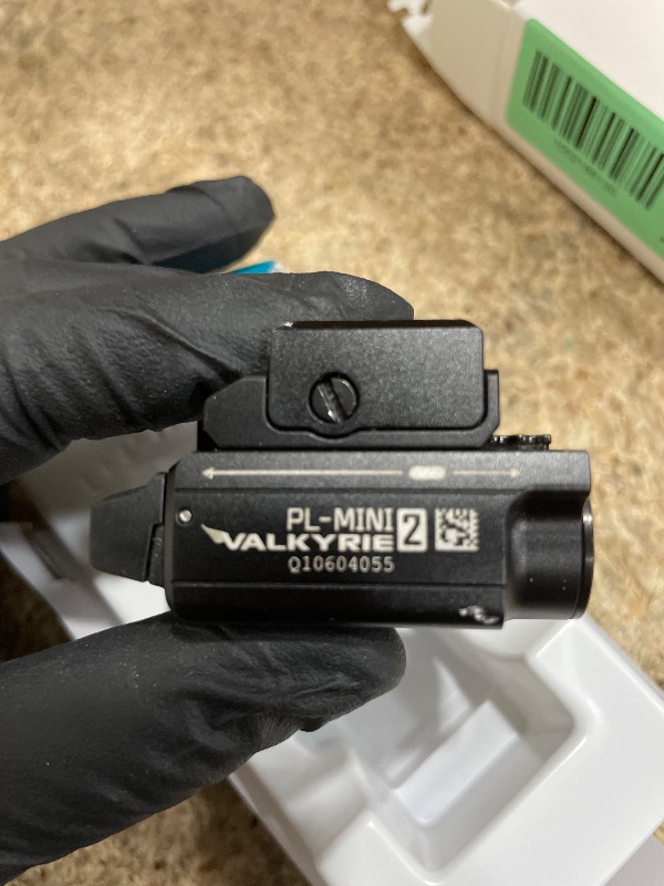 Photo 1 of **FOR PARTS/ NON-FUNCTIONAL** OLIGHT PL-Mini 2 Valkyrie 600 Lumens Magnetic USB Rechargeable Compact Weaponlight with Adjustable Rail, High Performance CW LED Tactical Flashlight with Built-in Battery