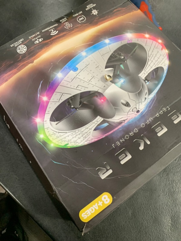Photo 1 of Foam UFO Drone for Kids – RC Plane with Colorful LED Lights, Remote Control Helicopter with Auto Hover, 2 Batteries (15 Mins Flight)