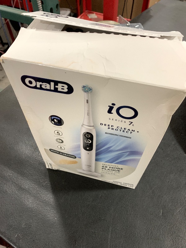 Photo 1 of Oral-B iO Deep Clean + Protect Rechargeable Electric Toothbrush, White with a iO Series 7 Toothbrush, 2 Replacement Brush Heads, and a Charging Travel Case