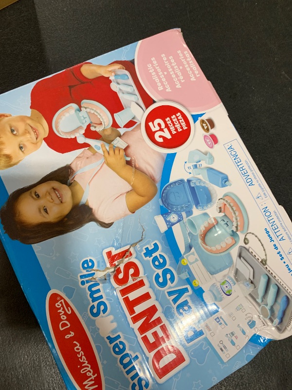 Photo 1 of Melissa & Doug Super Smile Dentist Play Set, 25-Piece Dentist Kit with Oversized Teeth, Large Tools & Accessories, Kids Toys for Girls & Boys 3+