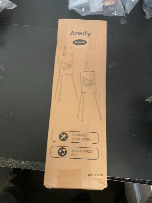 Photo 1 of Easel Stand for Sign, Aredy 63" Portable Painting Easel, Lightweight Metal Easels for Painting Canvas, Wedding Sign (2 Pack)