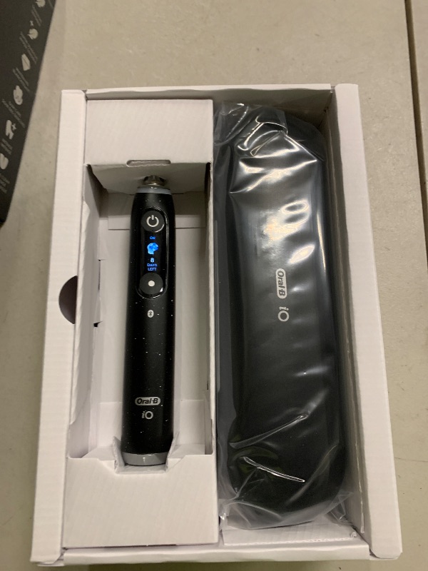 Photo 1 of Oral-B iO Series 10 Rechargeable Electric Toothbrush with Visible Pressure Sensor to Protect Gums, 2 Min Timer, 7 Cleaning Settings, 4 Replacement Toothbrush Heads, and Charging Travel Case, Black