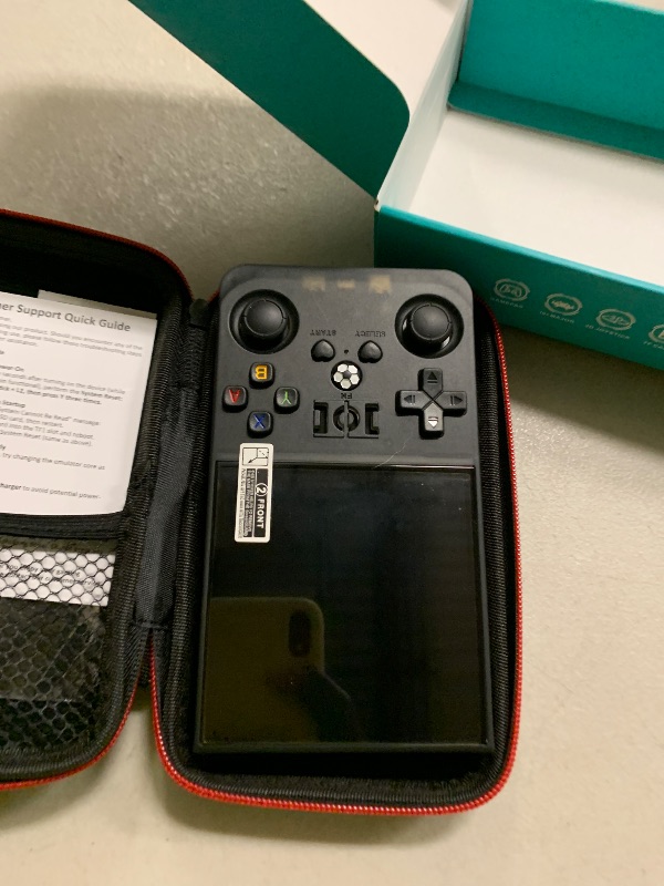 Photo 1 of ?R36MAX 4000mAh Portable Rechargeable Handheld Retro Game Console,Comfort Non-Slip Handheld Standing Retro Game Console with 64G TF Car,4.0-inch Screen,for Office,Black