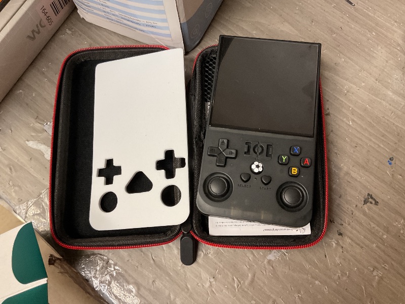 Photo 1 of ?R36MAX 4000mAh Portable Rechargeable Handheld Retro Game Console,Comfort Non-Slip Handheld Standing Retro Game Console with 64G TF Car,4.0-inch Screen,for Office,Black