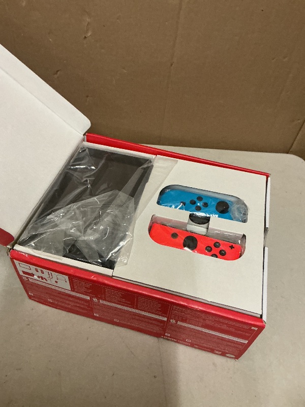 Photo 1 of Nintendo Switch with Neon Blue and Neon Red Joy-Con - Handheld Gaming Console