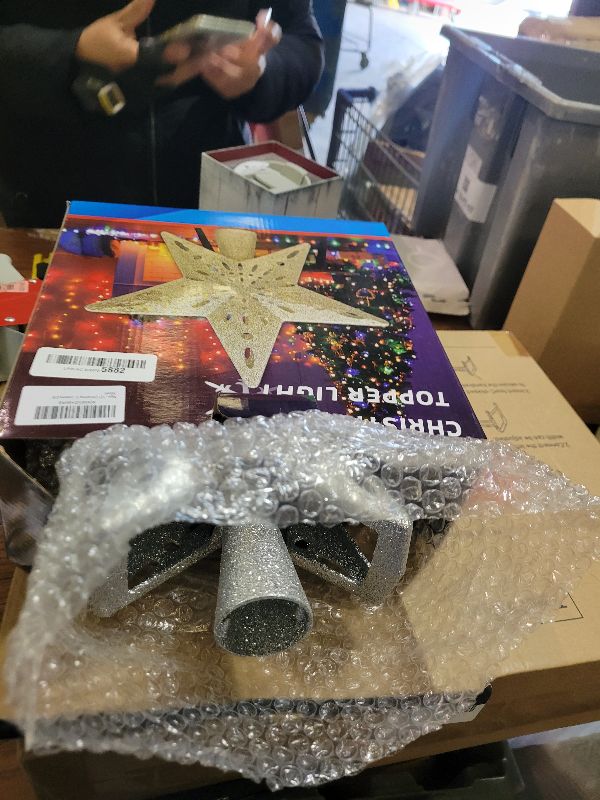 Photo 1 of 10" Christmas Tree Topper Projector with 6 Projection Modes, Lighted Christmas Tree Topper Star Built-in LED Rotation Light, 3D Glitter Dynamic TreeTop for Xmas Holiday Party Decorations Gift (Silver)