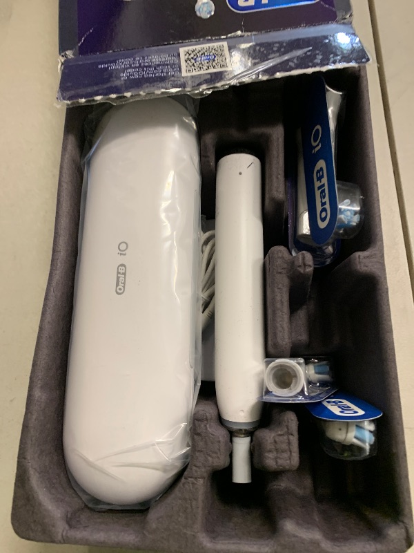 Photo 1 of Oral-B Rechargeable Electric Toothbrush, iO9 Genius, 7 Cleaning Modes, Interactive Display, Charging Travel Case, Visible Pressure Sensor, 4 Brush Heads, White Alabaster