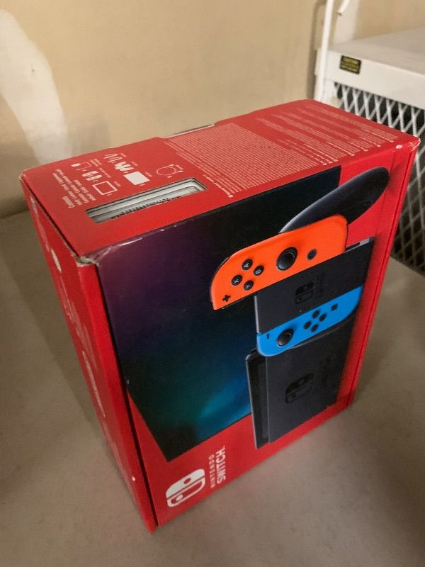 Photo 1 of Nintendo Switch with Neon Blue and Neon Red Joy-Con - Handheld Gaming Console
