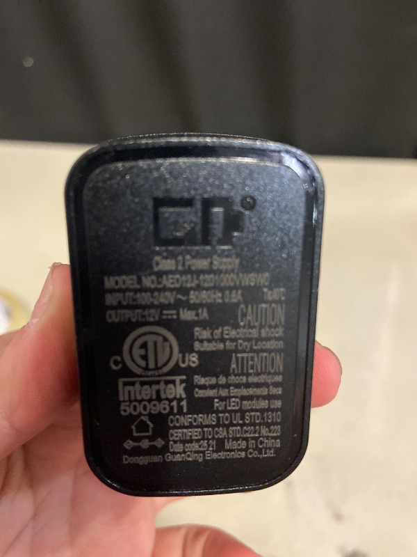 Photo 1 of Dongguan GuanQing Electronics power adapter (Model AED124-1201000/WSWO) designed for LED modules.
Input: 100-240v 50/60HZ