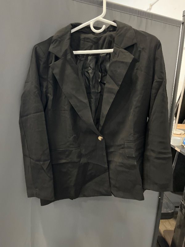 Photo 1 of Size Small Women' s black blazer featuring a lapel collar, long sleeves and a single-button closure.