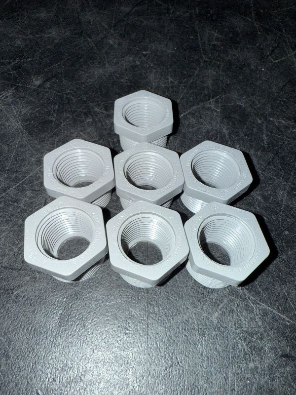 Photo 1 of 3/4" Male x 1/2" Female Threaded Reducer Bushing for PVC Pipe Fitting (Pack of 7) with Carlon E940d-ctn Pvc Conduit Coupling, 1/2"