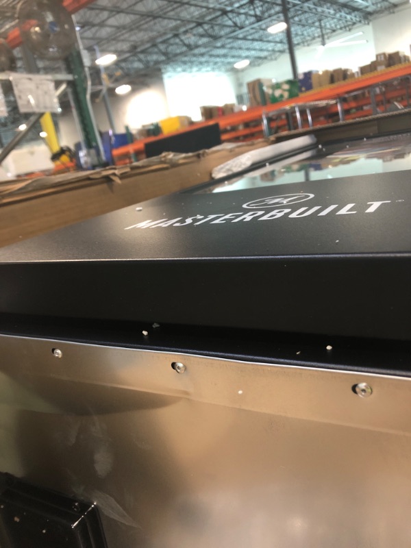 Photo 1 of ***HAS DENTS&******Masterbuilt® 40-inch Digital Electric Vertical BBQ Smoker with Leg Kit, Side Wood Chip Loader and 970 Cooking Square Inches in Black, Model MB20070122