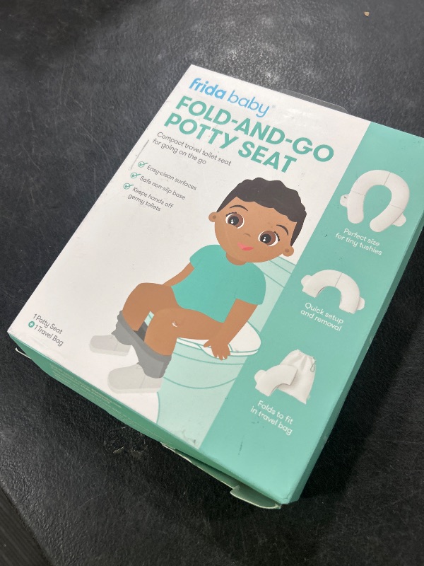 Photo 1 of Frida Baby Fold-and-Go Portable Potty Seat for Toilet, Foldable Travel Potty Seat for Toddler, Fits Round & Oval Toilets, Non-Slip Base, Handles, Includes Free Travel Bag