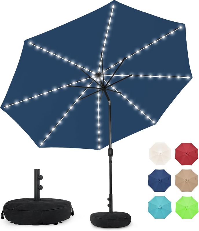 Photo 1 of Sundale Outdoor Solar 80 LED 9 ft Patio Umbrella with Sand Bag Umbrella Base, Outdoor Umbrella with Tilt and Crank, NAVY BLUE