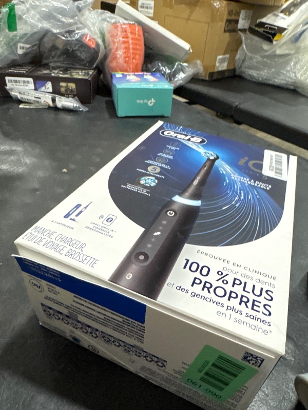 Photo 1 of Oral-B iO Series 5 Rechargeable Electric Toothbrush with Visible Pressure Sensor to Protect Gums, 2 Minute Timer, 5 Cleaning Settings, 1 Replacement Toothbrush Heads, and Travel Case, Black