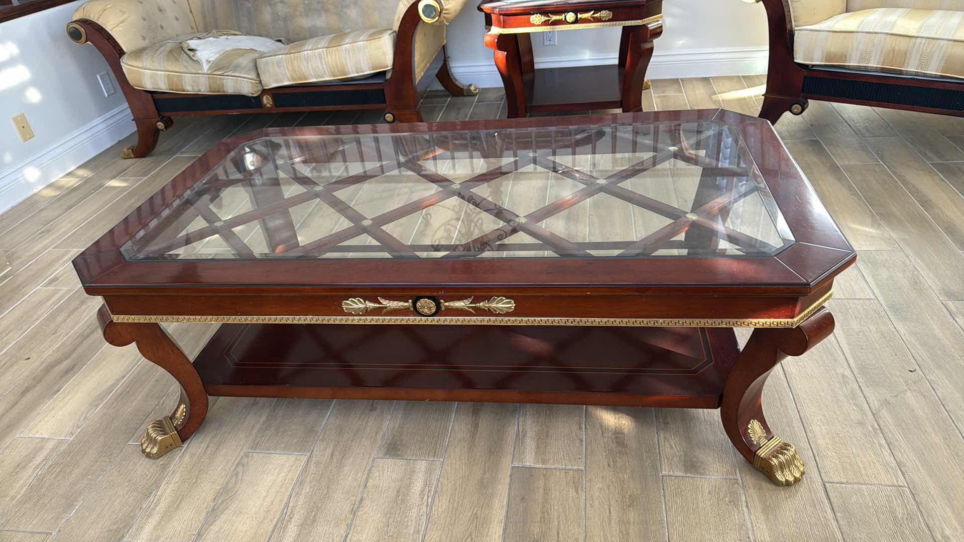 Photo 1 of VERSACE-STYLE SOLID WOOD COFFEE TABLE W GLASS TOP & GOLD TRIMMINGS 59” x 33” H19"