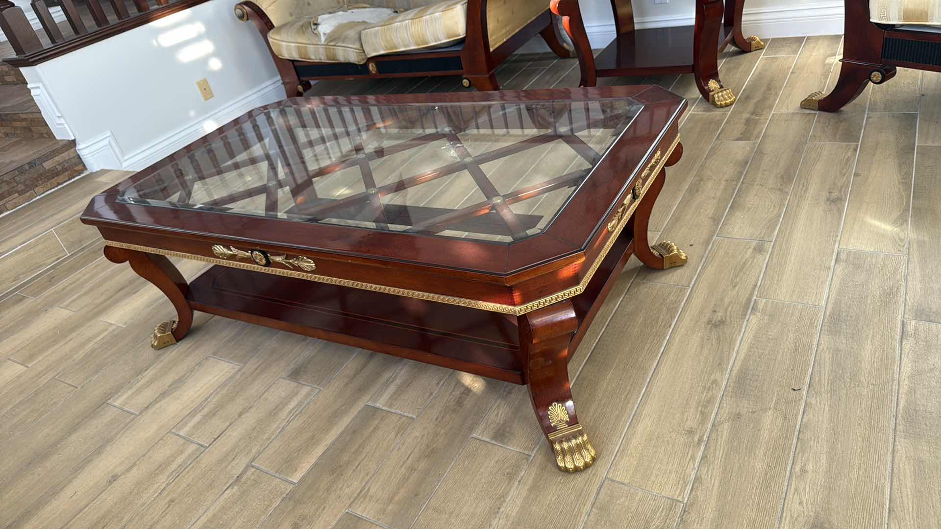 Photo 1 of VERSACE-STYLE SOLID WOOD COFFEE TABLE W GLASS TOP & GOLD TRIMMINGS 59” x 33” H19"