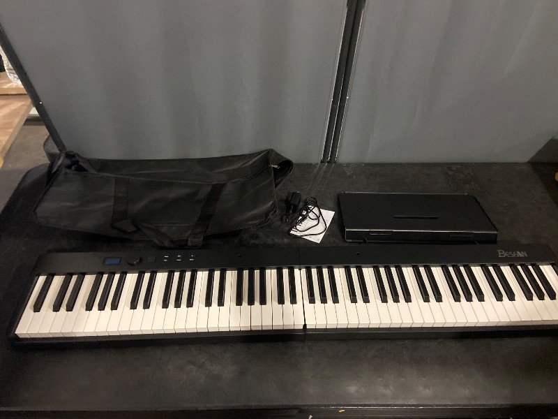 Photo 1 of BESFAN 88 Key Piano Keyboard BSP-10F Portable Folding Piano with Semi-Weighted Keys, 128 Tones, USB MIDI, Sustain Pedal, Music Stand for Beginners Gifts, Black

