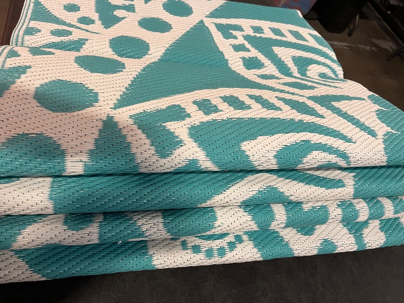 Photo 1 of Bsmathom Waterproof Outdoor Rug 6'x9' Reversible Boho Plastic Straw Patio Deck Camping Rugs, Indoor Outdoor Portable RV Mat Clearance Carpet for Outside, Porch, Balcony, Backyard, Beach, Pool,Teal
