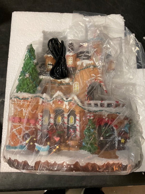 Photo 1 of MUMTOP Christmas Village Gingerbread House with Rotating Car, LED Colorful Lights Animated Candy House Figurine with Music for Indoor Holiday Christian Tabletop Decor